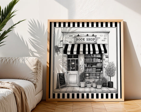 Black and white book shop print displayed in a light wood square frame beside a neutral sofa