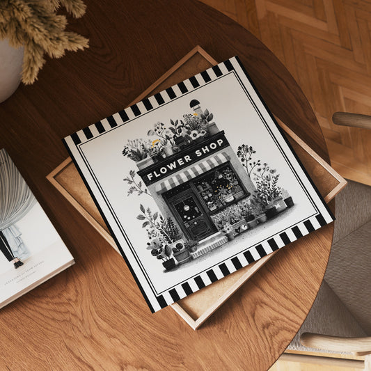 Square flower shop print displayed flat on a wooden table in a home interior