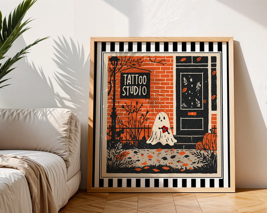 Tattoo studio ghost print displayed in a light wood square frame beside a neutral sofa