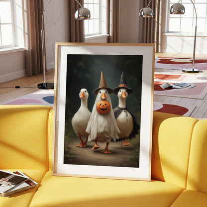 Halloween geese wall art displayed in a light wood frame on a yellow sofa
