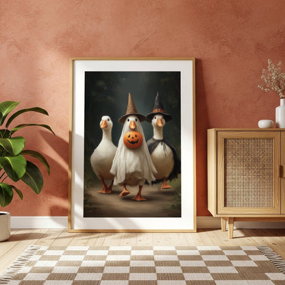 Halloween geese maximalist print displayed in a light wood frame against a warm terracotta wall