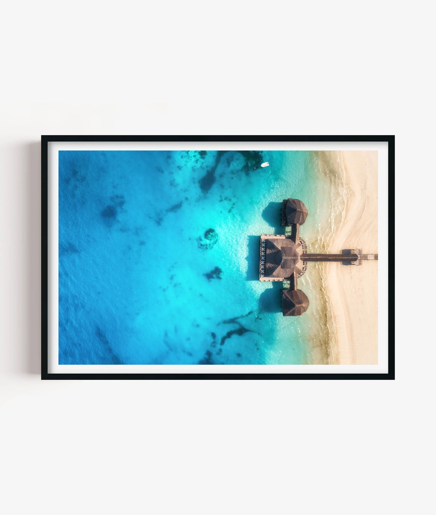 Bring bright coastal escape style to your space with this tropical beach resort print, featuring turquoise ocean water, soft white sand, overwater huts and a peaceful aerial island view for bedrooms, bathrooms, living rooms, offices, holiday homes and gallery walls.