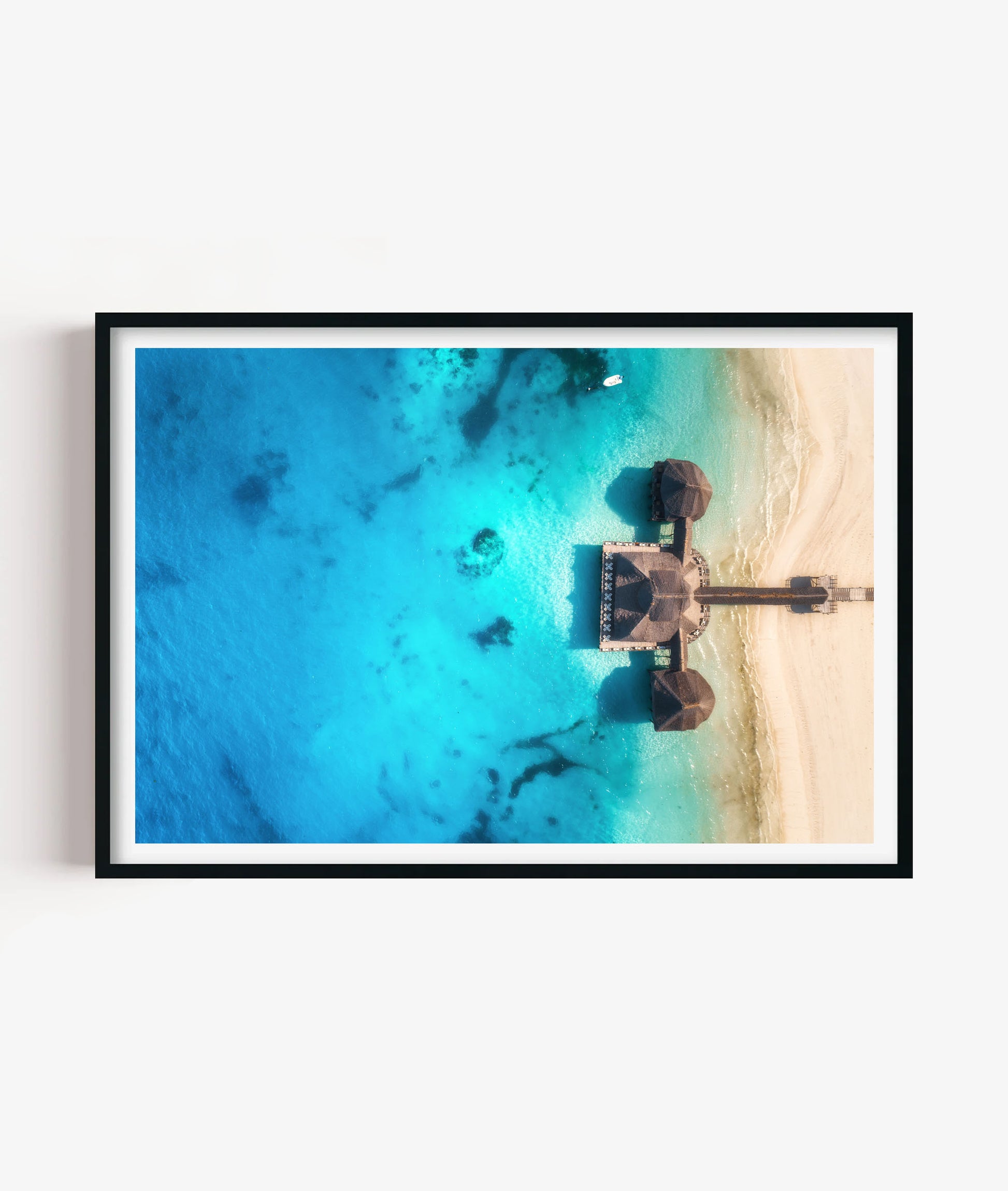Bring bright coastal escape style to your space with this tropical beach resort print, featuring turquoise ocean water, soft white sand, overwater huts and a peaceful aerial island view for bedrooms, bathrooms, living rooms, offices, holiday homes and gallery walls.