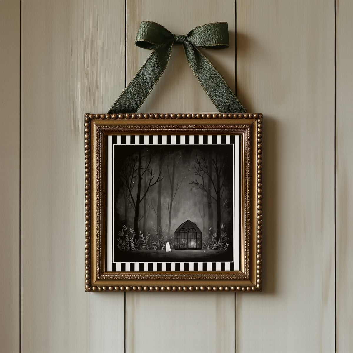 Ghost greenhouse gothic print displayed in an ornate gold frame with green ribbon