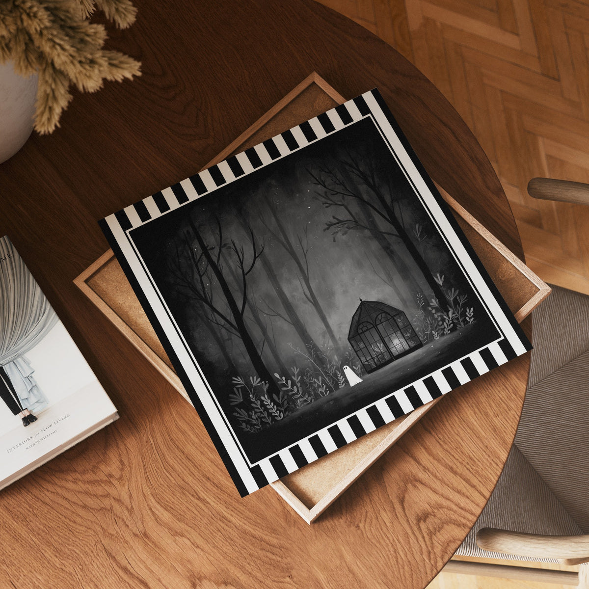 Ghost greenhouse gothic print shown as a square print mockup on a wooden table