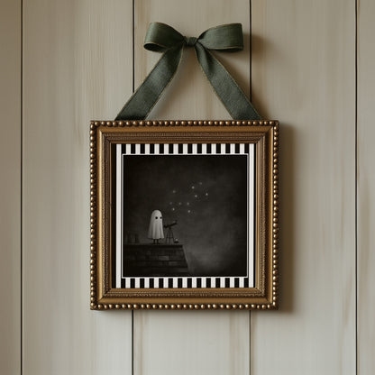 Ghost stargazing gothic print displayed in an ornate gold frame with green ribbon