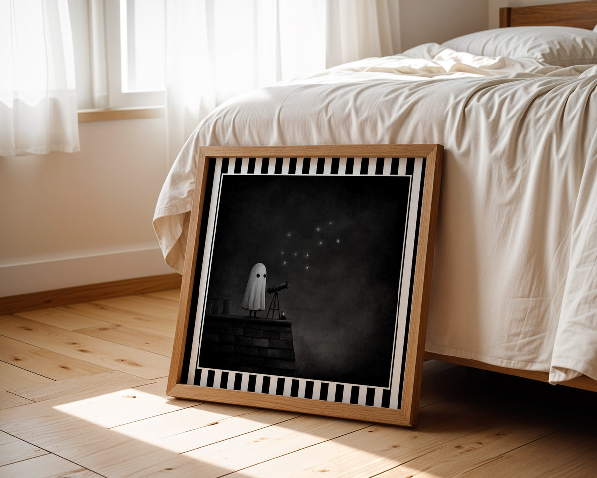 Ghost stargazing gothic print in a light wood frame leaning beside a bed