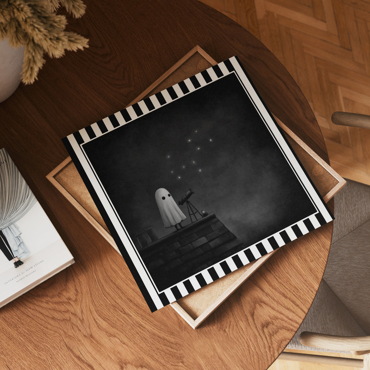 Ghost stargazing gothic print shown as a square print mockup on a wooden table