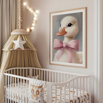 White duck pink bow nursery wall art displayed above a cot