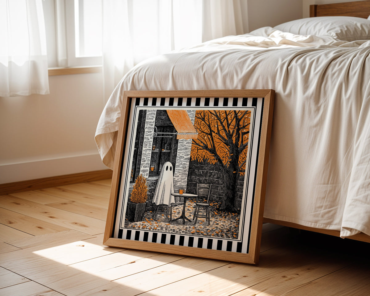 Autumn ghost café print displayed beside a bed in a light wood square frame