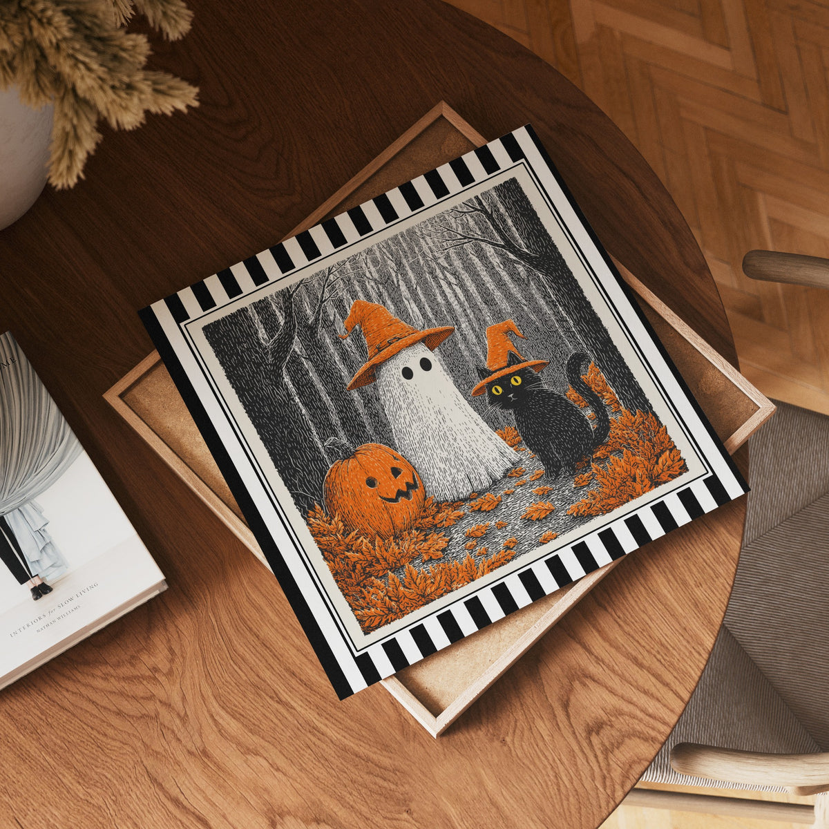 Square ghost and black cat Halloween print displayed flat on a wooden table