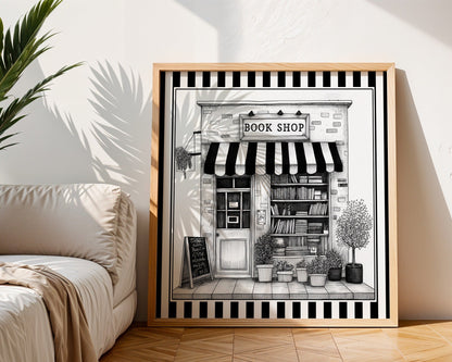 Black and white book shop print displayed in a light wood square frame beside a neutral sofa
