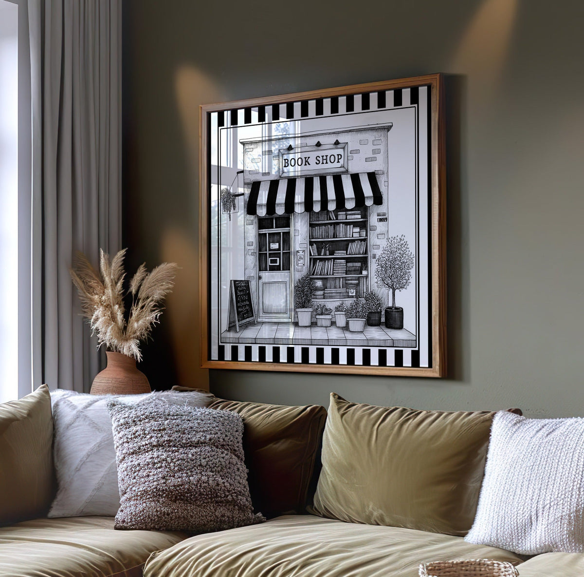 Black and white book shop wall art displayed on a dark green wall above a sofa