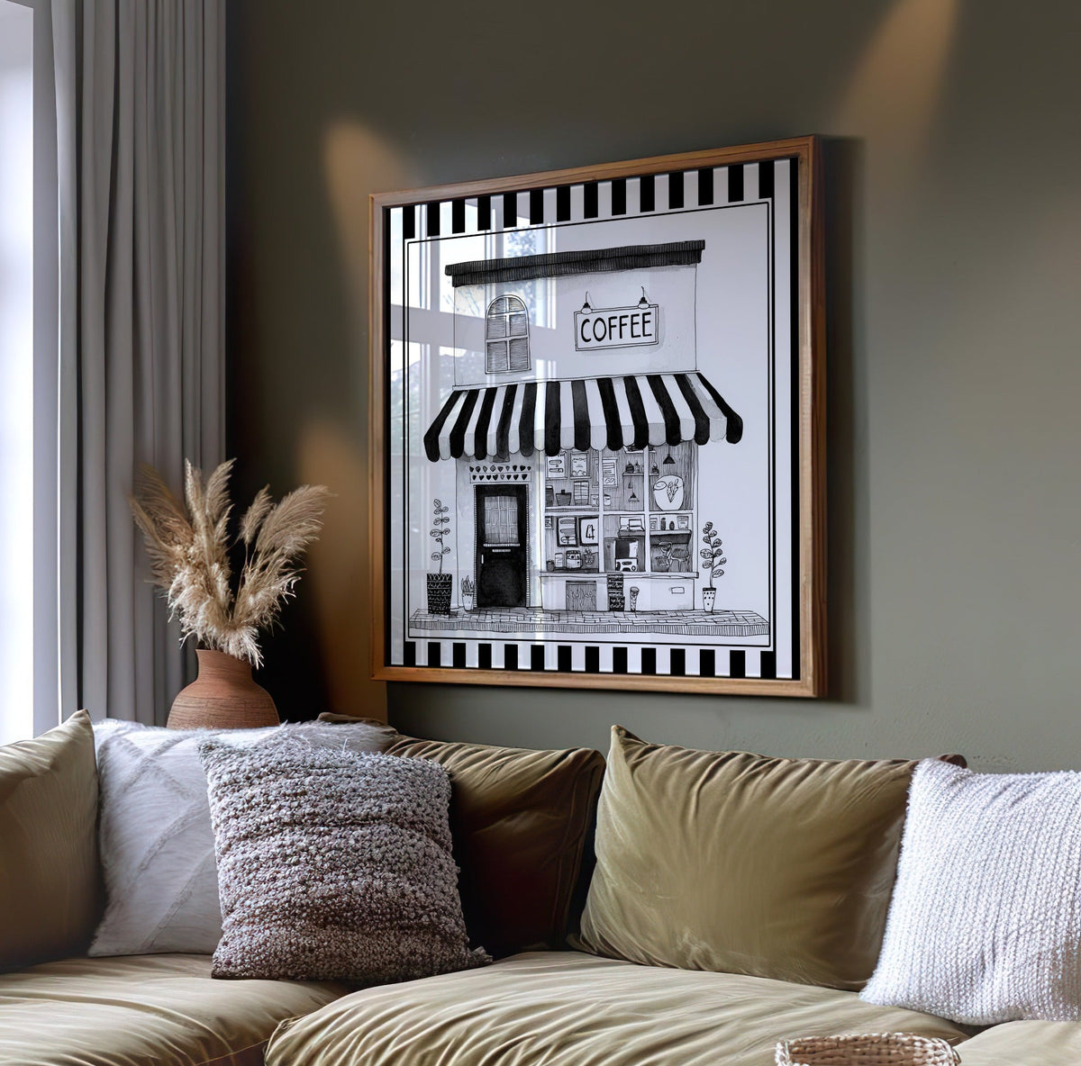 Black and white coffee shop wall art displayed on a dark green wall above a sofa