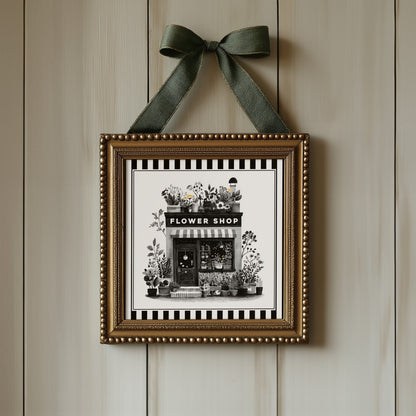 Flower shop botanical print displayed in an ornate gold square frame with ribbon