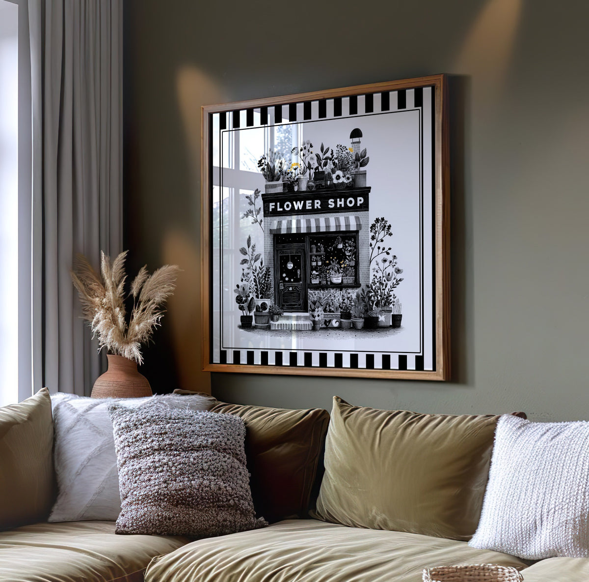 Black and white flower shop botanical print displayed on a dark green wall above a sofa