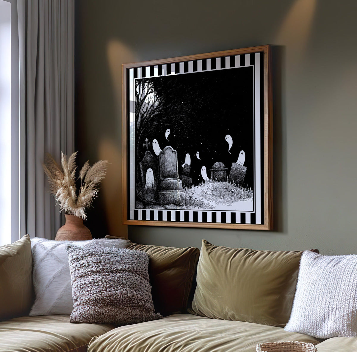 Ghost graveyard wall art displayed on a dark green wall above a sofa