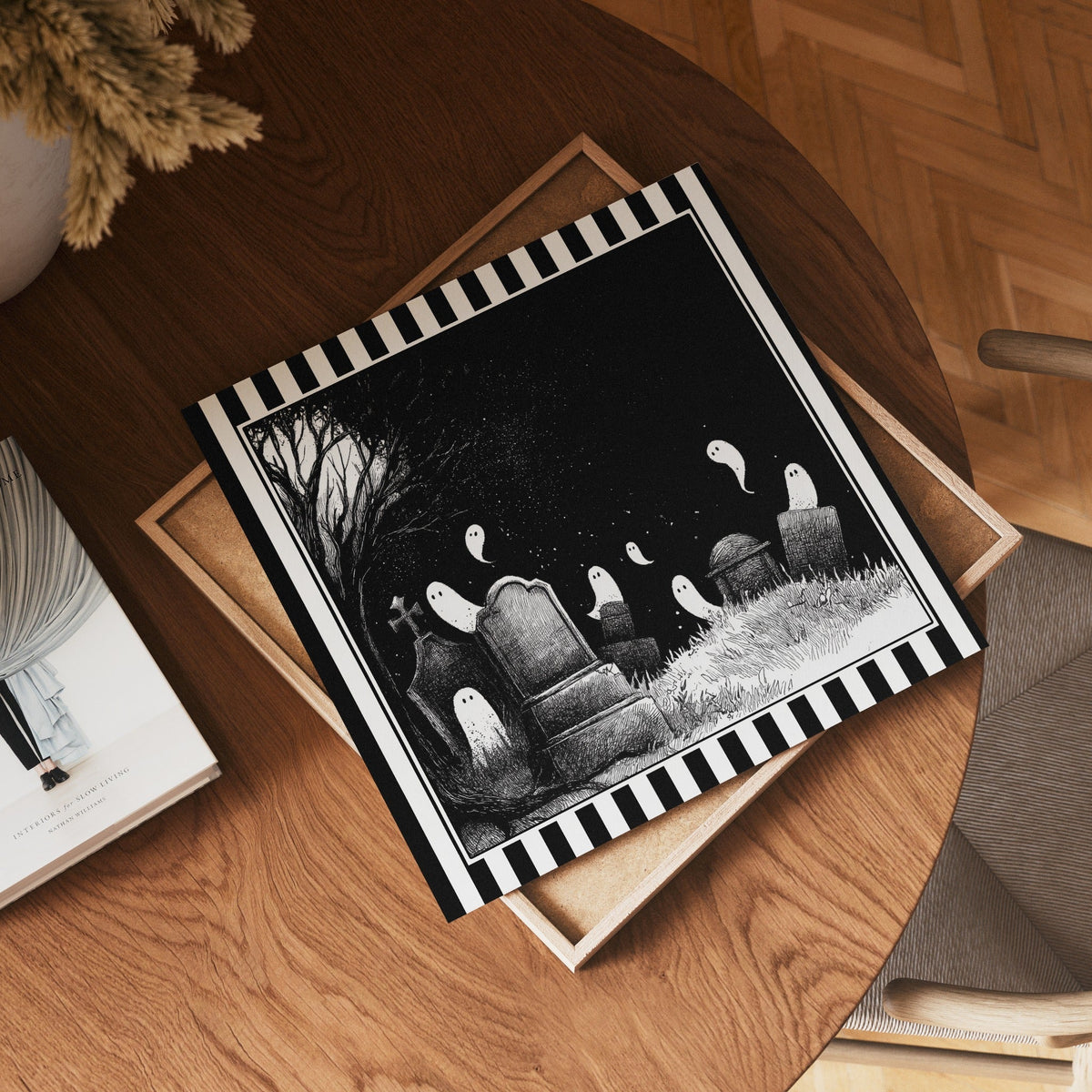 Square ghost graveyard print displayed flat on a wooden table