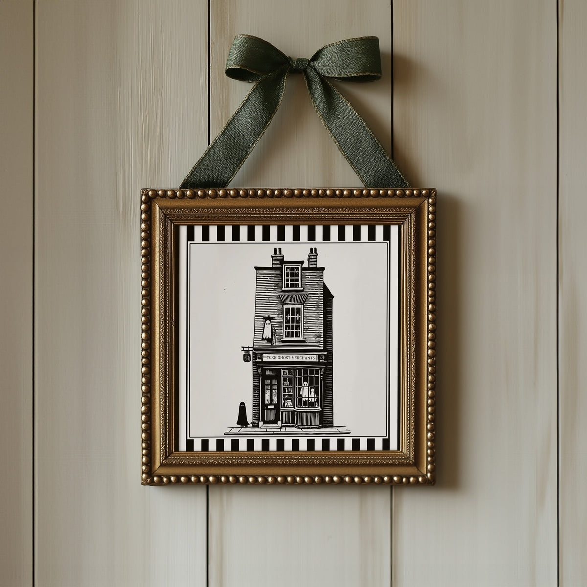 York ghost shopfront print displayed in an ornate gold square frame with ribbon
