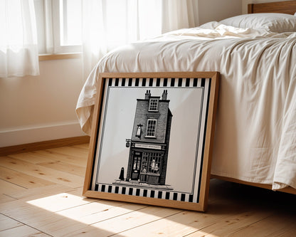 York ghost shopfront print displayed beside a bed in a light wood square frame