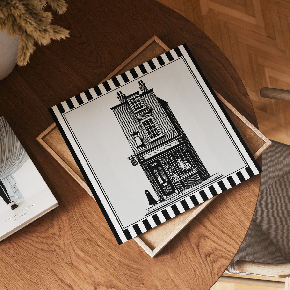 Square York ghost shopfront print displayed flat on a wooden table