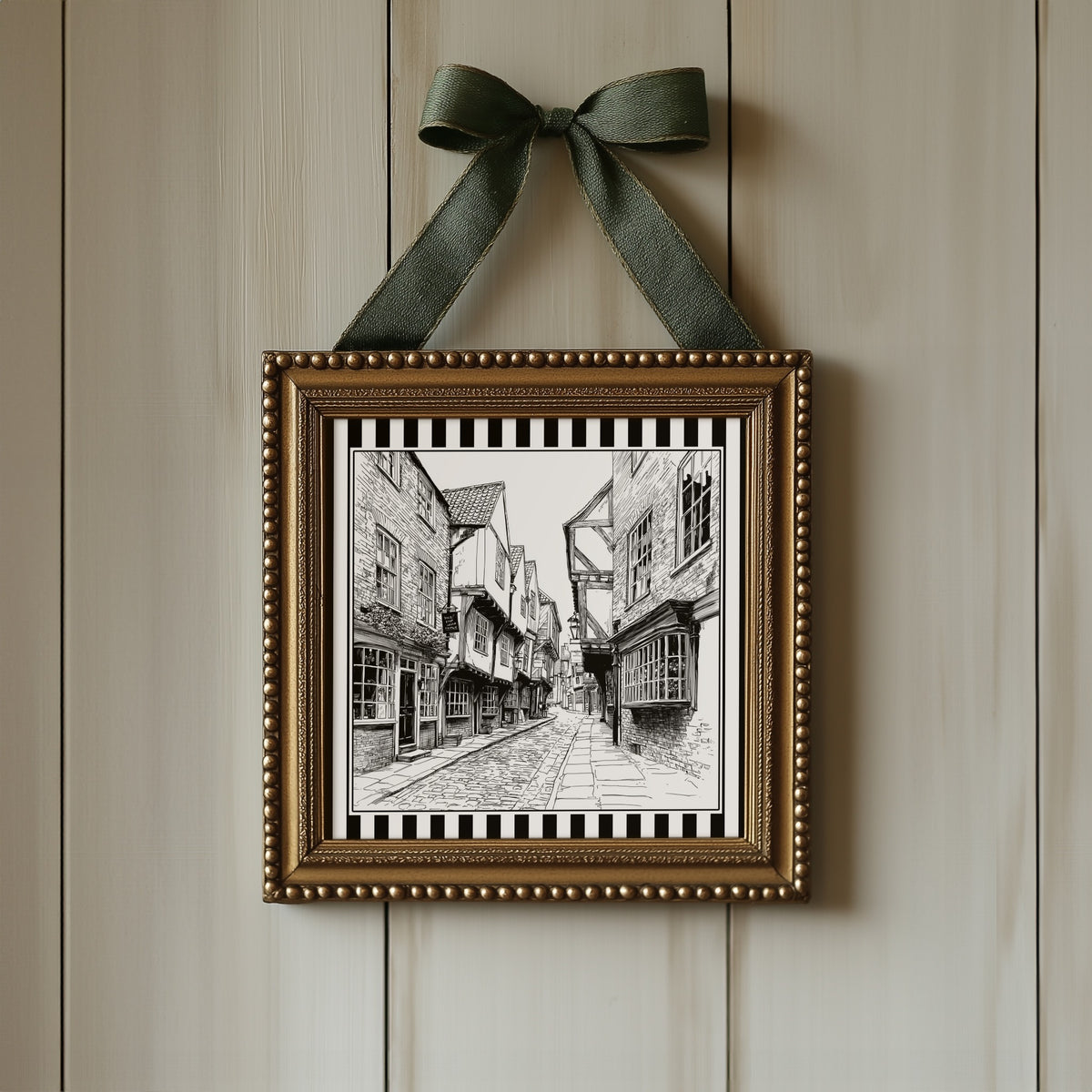 Black and white York Shambles street print displayed in an ornate gold square frame with ribbon