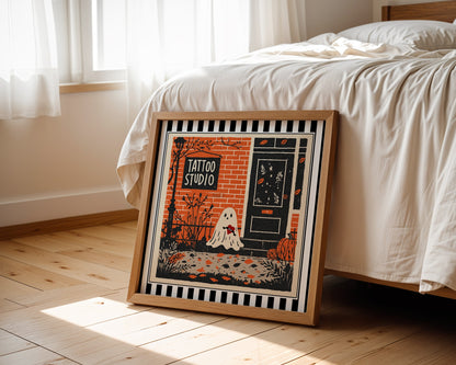 Tattoo studio ghost print displayed beside a bed in a light wood square frame