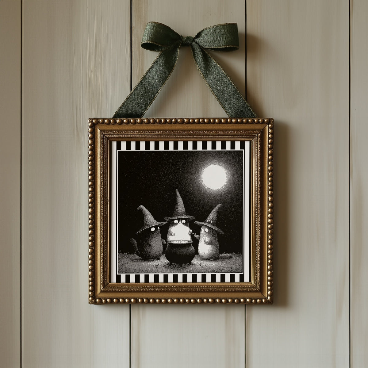 Witch cats moonlit print displayed in an ornate gold square frame with ribbon