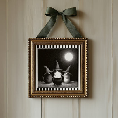Witch cats moonlit print displayed in an ornate gold square frame with ribbon